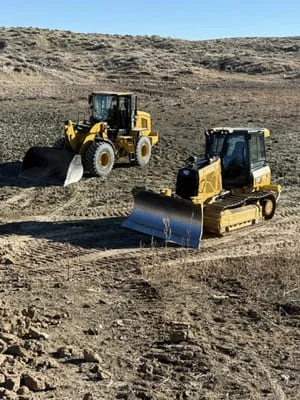 Wheel loader and track dozer performing site grading and soil compaction on excavation project